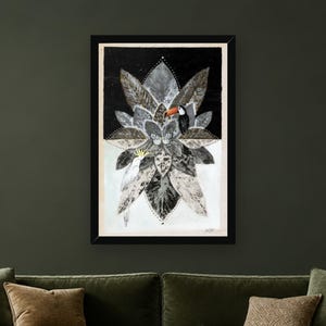 May include: A framed rectangular art print featuring a central mandala-like arrangement of grey and black leaves. A toucan with an orange beak sits on the right, while a white cockatoo with a yellow crest is positioned on the lower left side.