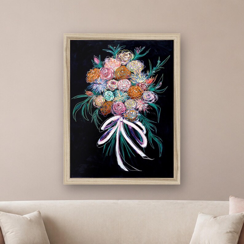 May include: A framed wall art print featuring a vibrant bouquet of flowers in shades of pink, orange, blue, and white against a solid black background. The floral arrangement is tied with a white ribbon and accented by green foliage outlines.