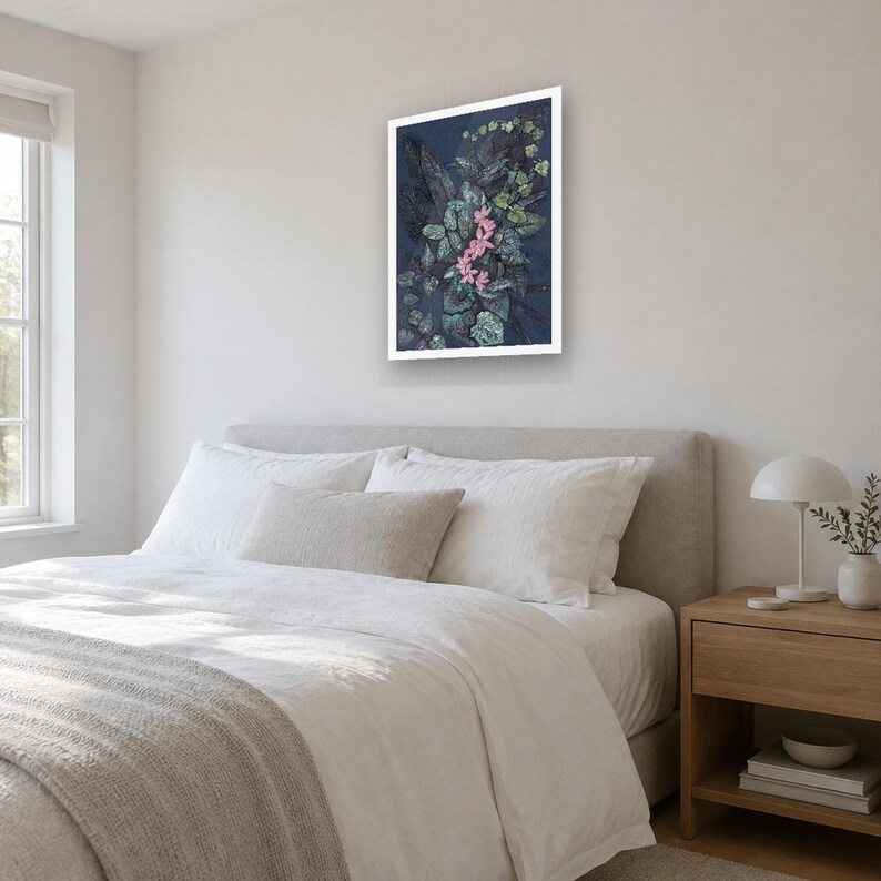 May include: A rectangular wall art print featuring a dark navy blue background with a dense arrangement of green foliage and a central cluster of small, vibrant pink flowers, all enclosed within a clean, white frame.