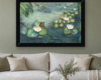 May include: A framed painting of a pond featuring green lily pads and white water lilies floating on the water surface. A brown butterfly is perched on one of the white flowers. The artwork is enclosed in a simple black rectangular frame.