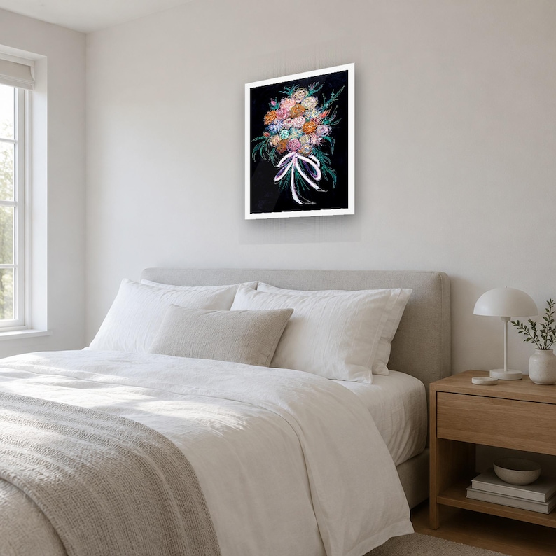 May include: A framed wall art print featuring a vibrant bouquet of multi-colored flowers including pink, orange, and blue blossoms with green foliage, tied together with a white ribbon against a solid black background.