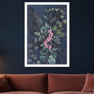 May include: A framed vertical wall art piece featuring a dark navy blue background with a dense arrangement of deep green and black foliage. A central cluster of five-petaled light pink flowers stands out against the dark leaves.