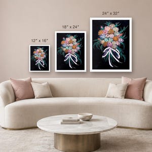 May include: Three rectangular wall art prints featuring a colorful floral bouquet on a black background, tied with a white ribbon. The prints are labeled with dimensions of 12 by 16 inches, 18 by 24 inches, and 24 by 32 inches respectively.