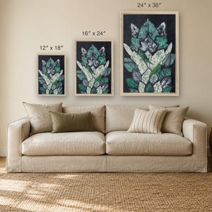 May include: Three framed rectangular wall art prints featuring a green and white leaf pattern on a black background. The prints are labeled with dimensions of 12" x 18", 16" x 24", and 24" x 36" respectively, displayed in light wood frames.