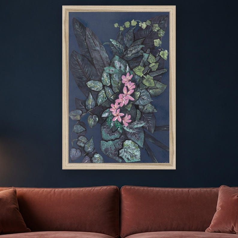 May include: A framed wall art piece featuring a dark navy blue background with a central cluster of deep green, textured foliage and a vertical arrangement of five light pink, five-petaled flowers. The frame is a light, natural wood color.