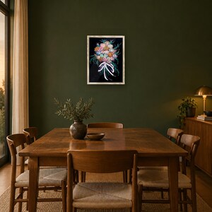 May include: A rectangular framed wall art piece featuring a vibrant floral bouquet illustration against a black background, tied with a white ribbon. The artwork is displayed in a light-colored wooden frame and hung on a dark olive green wall.