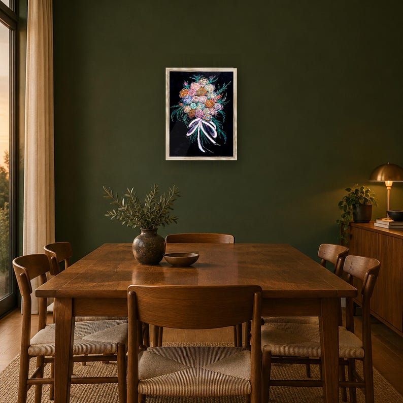 May include: A rectangular framed wall art piece featuring a vibrant floral bouquet illustration against a black background, tied with a white ribbon. The artwork is displayed in a light-colored wooden frame and hung on a dark olive green wall.