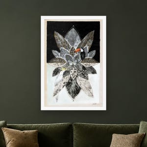 May include: A framed rectangular art print featuring a symmetrical arrangement of gray and black leaves. A toucan with an orange beak is positioned on the right, while a white cockatoo with a yellow crest is on the left, all on a split background.