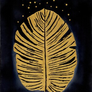 May include: A gold-painted leaf illustration centered on a dark navy blue background. The leaf features prominent black veins and texture, with small gold dots scattered in an arc above the top edge of the leaf, creating a contrast.