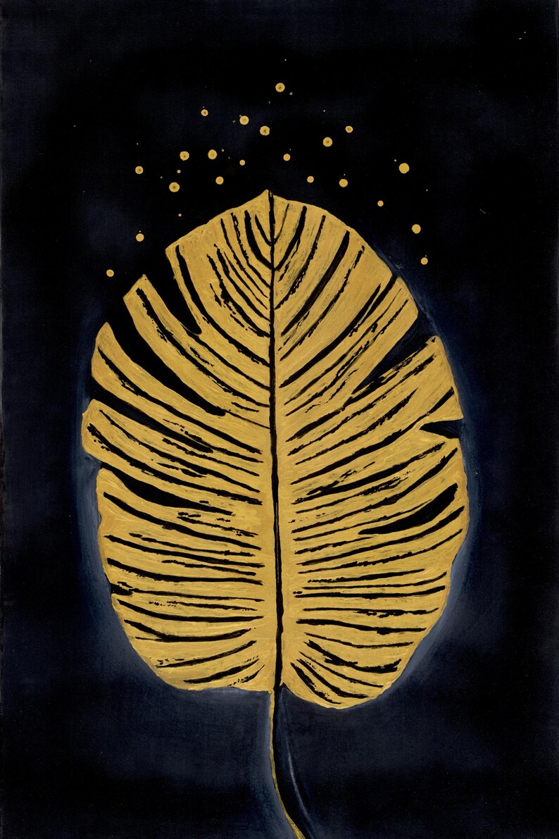 May include: A gold-painted leaf illustration centered on a dark navy blue background. The leaf features prominent black veins and texture, with small gold dots scattered in an arc above the top edge of the leaf, creating a contrast.