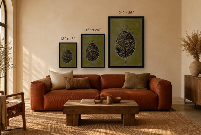 May include: Three framed wall art prints featuring a dark leaf illustration on a muted olive green background. The prints are labeled with dimensions of 12" x 18", 16" x 24", and 24" x 36" respectively, displayed in black frames.