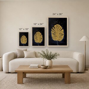 May include: Three framed wall art prints featuring a gold leaf illustration on a dark blue background. The prints are labeled with dimensions of 12 inches by 18 inches, 16 inches by 24 inches, and 24 inches by 36 inches respectively.