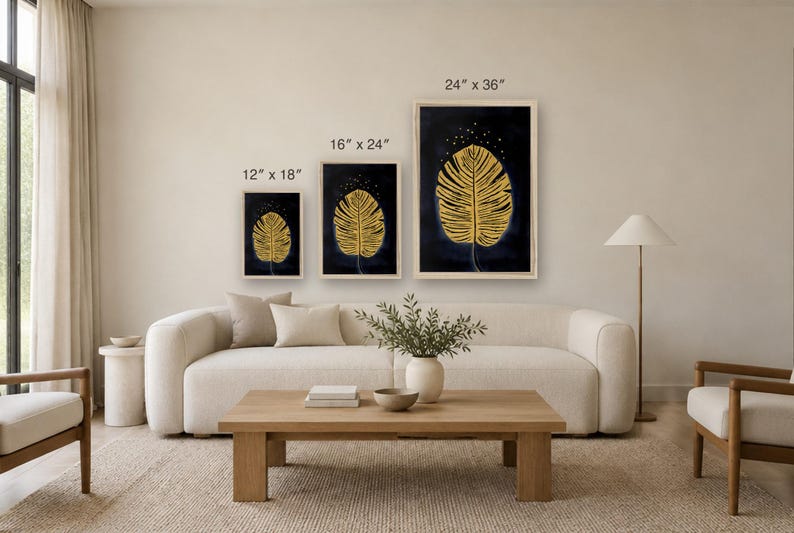 May include: Three framed wall art prints featuring a gold leaf illustration on a dark blue background. The prints are labeled with dimensions of 12 inches by 18 inches, 16 inches by 24 inches, and 24 inches by 36 inches respectively.