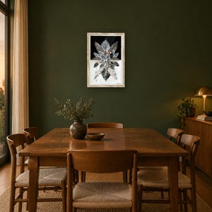 May include: A framed rectangular wall art piece featuring a central collage of layered, patterned leaves in shades of black, white, and gray, with a small toucan bird perched among the foliage against a contrasting black and white background.