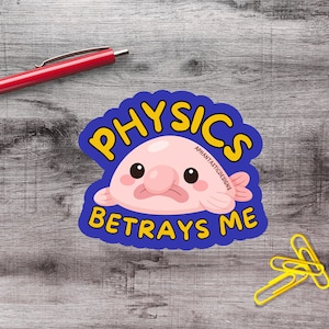 May include: A sticker featuring a cartoon blobfish with the text "PHYSICS BETRAYS ME" in yellow letters on a blue background. The blobfish is pink with black eyes and a sad expression. A red pen and yellow paper clips are also visible.