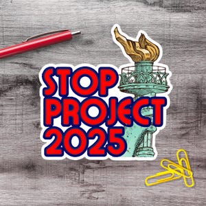 a sticker with the text "STOP PROJECT 2025" and an illustration of the Statue of Liberty with a torch on top.