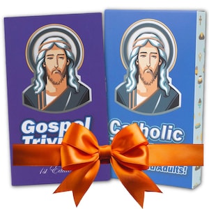 May include: Two boxed games, Gospel Trivia and Catholic Trivia, are wrapped with an orange satin ribbon and bow. The game boxes are purple and blue, each featuring an illustration of Jesus. Text on the boxes includes "For Adults!"