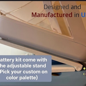 May include: An adjustable stand with a light-colored frame and a clear panel. The text on the image reads "Designed and Manufactured in USA" and "Battery kit come with the adjustable stand (Pick your custom on color palette)".