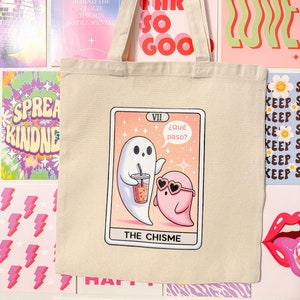 Spill the chisme in style with this eco-friendly recycled cotton canvas tote bag, featuring a fun tarot card-inspired design of two ghosts caught in a gossip session