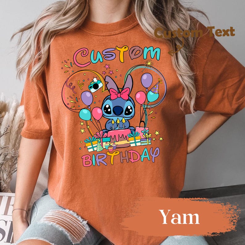 May include: Orange t-shirt with a colorful graphic featuring a cartoon character, balloons, and the words "Custom Birthday." The design includes a cake, presents, and stars. The shirt is a solid orange color.