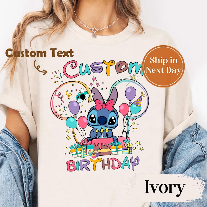 May include: Ivory-colored t-shirt featuring a cartoon character with a birthday cake, balloons, and the word "BIRTHDAY". The shirt has the text "Custom" above the character. The design includes a blue character with a pink bow.