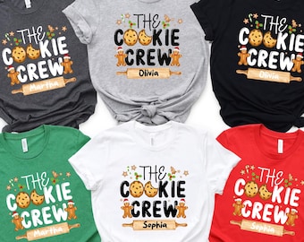 May include: Six Christmas themed t-shirts in different colors with the text "The Cookie Crew" and a gingerbread man holding a rolling pin. The shirts are personalized with names: Martha, Olivia, and Sophia.