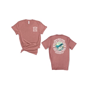 May include: Two heather pink t-shirts. The front shirt has a small white graphic of a building. The back shirt has a white circle graphic with the text "Your Grup Name Your Location Vacation 2024 Adventure Time".