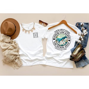 May include: White t-shirt with a black graphic of a building on the front and a black circle with the text "Your Group Name Your Location Vacation 2024 Adventure Time" on the back.
