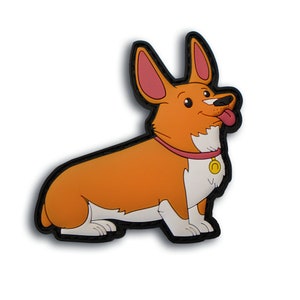 May include: A cartoon-style patch featuring a corgi dog in a sitting position. The dog has orange fur, white chest and paws, and a pink collar with a gold pendant. The patch has a black border and a white background.