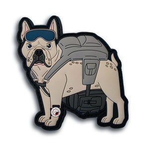 May include: A tan and gray patch featuring a bulldog wearing goggles and a backpack. The bulldog has a watch on its front leg. The patch has a black border and is on a white background.