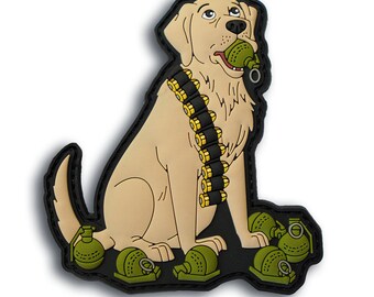 May include: A tan-colored patch featuring a cartoon Labrador Retriever with a black outline. The dog wears a black bandolier with gold-colored bullets and holds a green grenade in its mouth. Several green grenades are at its feet.