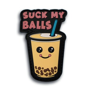 May include: A black patch featuring a cartoon bubble tea drink with a smiling face and a blue straw. The text "SUCK MY BALLS" is displayed above the drink in pink letters.
