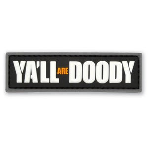 May include: A rectangular black patch with a raised white border and white lettering that reads YA'LL ARE DOODY, with the word ARE printed in a smaller orange font between the words YA'LL and DOODY. The patch has a clean, flat design.