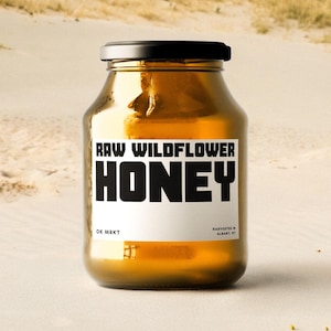 May include: A glass jar of raw wildflower honey with a white label that reads "RAW WILDFLOWER HONEY", "OK MRKT", and "HARVESTED IN ALBANY, NY".