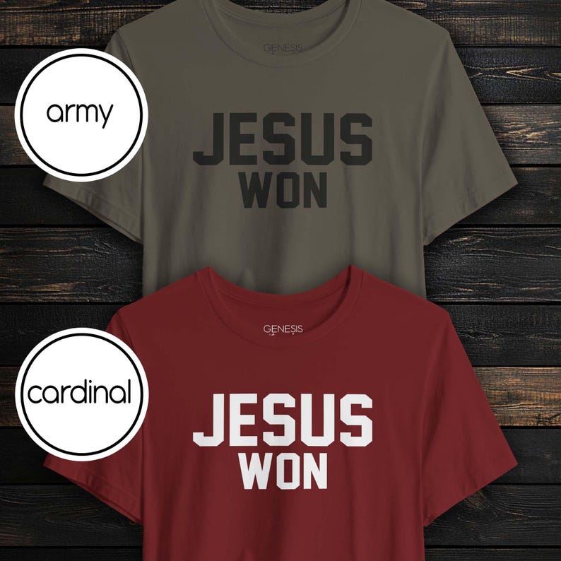 May include: Two short-sleeve crew neck t-shirts. The top shirt is army green with black text that reads JESUS WON. The bottom shirt is cardinal red with white text that reads JESUS WON. Both shirts feature the brand name GENESIS at the neckline.