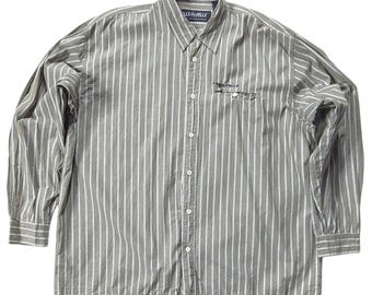 May include: A long-sleeved, striped button-down shirt in a green and white color scheme. The shirt has a small pocket on the left chest with the text "GILE & PELLE" embroidered on it.