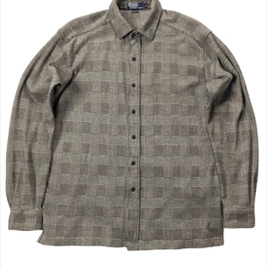 May include: A long-sleeved plaid button-down shirt in a brown and white pattern. The shirt has a collared neckline and a button closure. The label on the shirt reads "Polo Ralph Lauren".