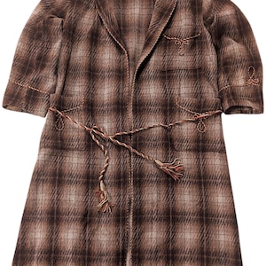 May include: A brown plaid robe with short sleeves and a shawl collar. The robe has a matching belt and decorative stitching along the edges. A small pocket is on the chest. The robe is made of a soft, woven fabric.