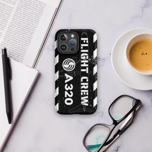 May include: Black and white phone case with a white airplane silhouette and the text "FLIGHT CREW A320".