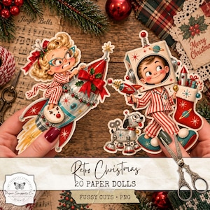 May include: A set of die-cut paper dolls featuring a blonde character in red and white striped pyjamas riding a rocket, and a character wearing a robot helmet with a ray gun and a Christmas stocking, accompanied by a small mechanical dog figure.