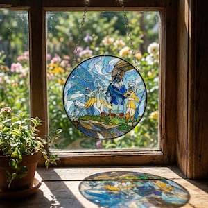 May include: A round stained glass window hanging in a wooden window frame. The artwork depicts a scene with figures in blue and yellow, set against a backdrop of swirling blue and white. The window is suspended by a silver chain.