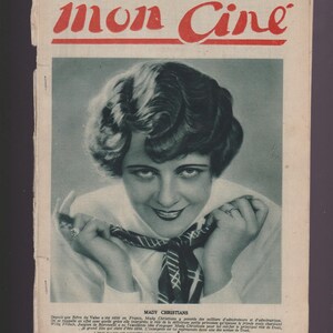May include: Vintage French magazine cover from 1928, titled "mon Cine" in red. Features a black and white portrait of Mady Christians, with text below. The magazine cover has a worn appearance.
