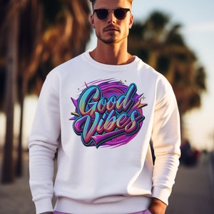 May include: A white sweatshirt with a colorful graphic print that says "Good Vibes". The person wearing the sweatshirt is wearing sunglasses and pink pants.