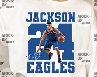 May include: White sweatshirt featuring a blue graphic with the name "JACKSON" above the number "24" and the word "EAGLES". The graphic includes an image of a basketball player in a blue uniform.