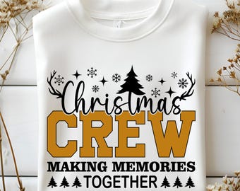 May include: White sweatshirt with the text "Christmas CREW MAKING MEMORIES TOGETHER" in black and gold. The design includes snowflakes, antlers, and a Christmas tree. A festive holiday-themed top.