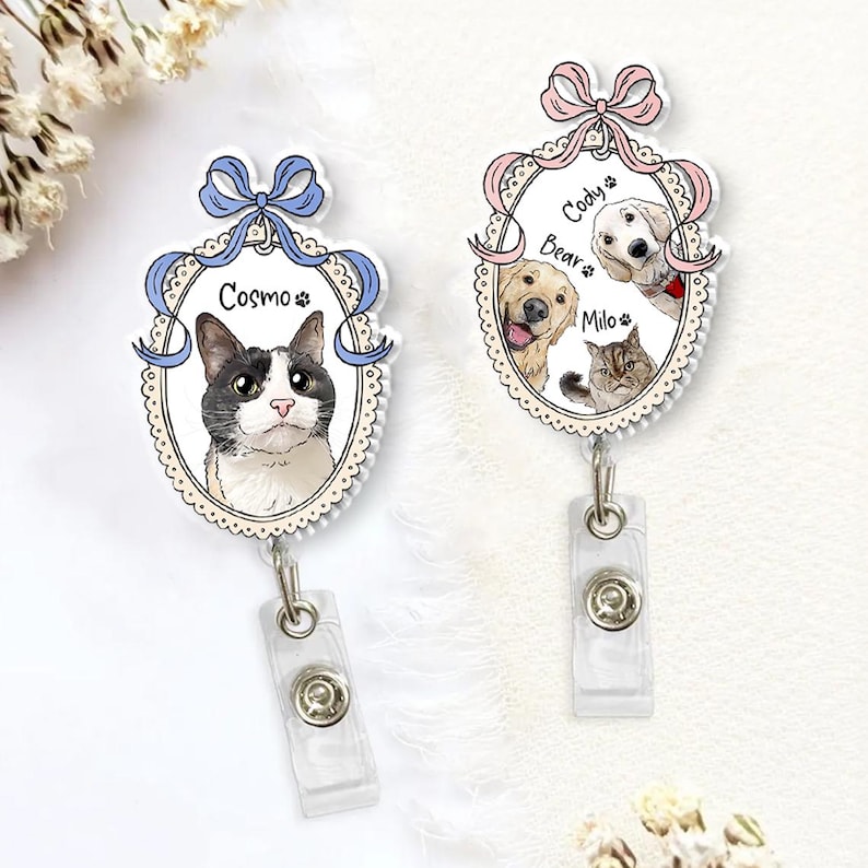 May include: Two personalised pet badge reels. One features a cat named Cosmo, the other has a golden retriever, a cat, and a white dog named Bear, Cody, and Milo. Each badge reel has a decorative oval frame with a bow at the top and a clear plastic clip.