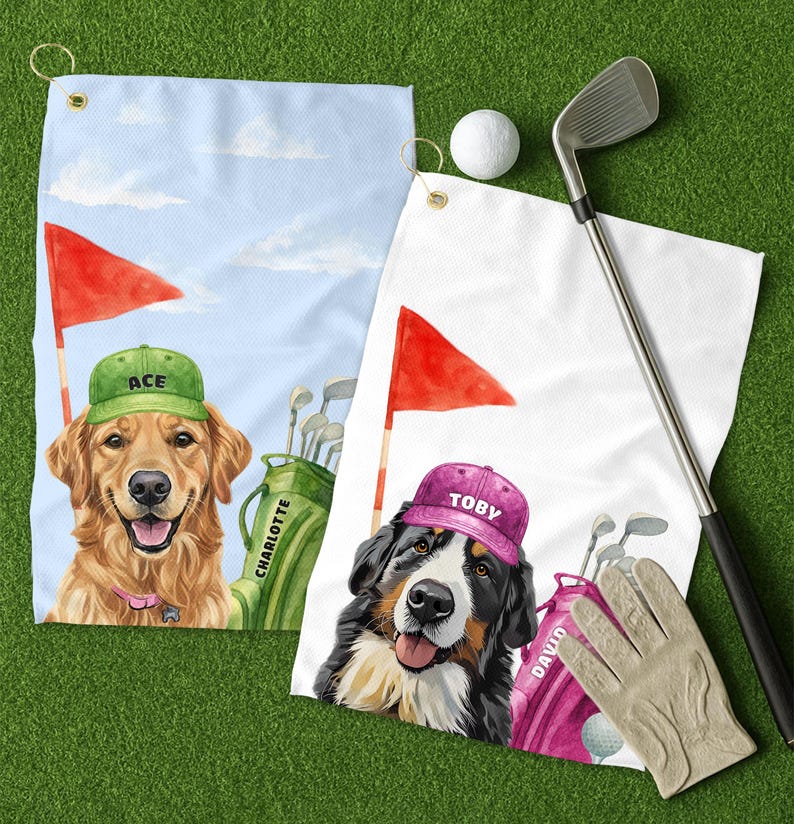 May include: Two golf towels with dog portraits. One features a golden retriever wearing a green cap with "ACE" on it, the other a Bernese Mountain Dog in a pink cap with "TOBY". Golf clubs, a golf ball, and a golf glove are also visible.