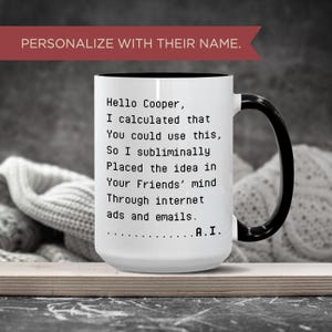 Puede incluir: Taza de cerámica blanca con asa y borde negros. La taza presenta el texto "Hello Cooper, I calculated that you could use this..." y las palabras "PERSONALIZA CON SU NOMBRE" en la parte superior.