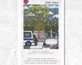 May include: A trading card featuring an illustration of a tree behind a fence, with a police car and figures. The card has German text, including "Görli Zaun" and speech bubbles. A red hand gesture is in the upper left corner.