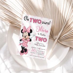 May include: A pink and white invitation card featuring Minnie Mouse, with the text "Oh Two Dles!" and "Olivia is turning two." The card includes event details like date, time, and location, with a polka dot background.